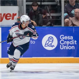 Ice hockey player from the Tri-City Americans skating on the rink during a game.