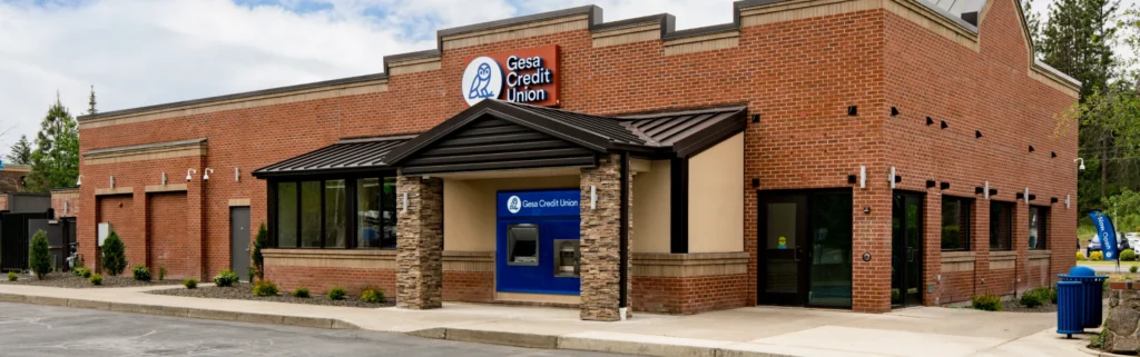 Exterior view of a Gesa Credit Union branch with an ATM and entrance on a sunny day.