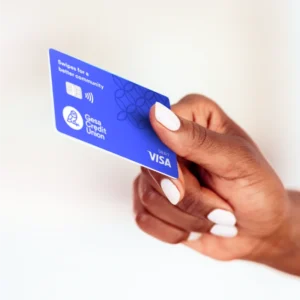 Hand holding a blue Gesa Credit Union Visa debit card with contactless payment symbol.