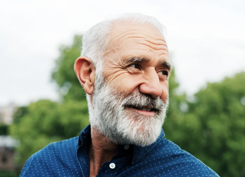 Older man smiling outdoors