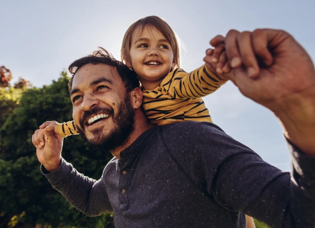 Father carrying his child on shoulders