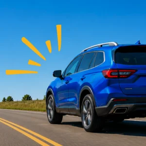 Blue SUV driving on a sunny rural highway, rear three-quarter view.